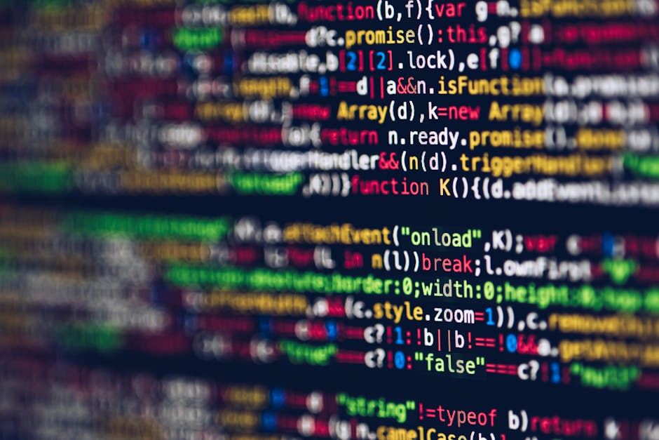 A close-up view of a computer screen displaying a colorful, blurred code editor with lines of programming code in various colors, including yellow, pink, green, blue, and white, indicative of software
